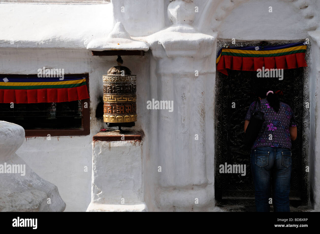 Bodhnath Bodnath Boudhanath Buddhist stupa Nepal Kathmandu woman pray praying worship pilgrim faithful prayer Stock Photo