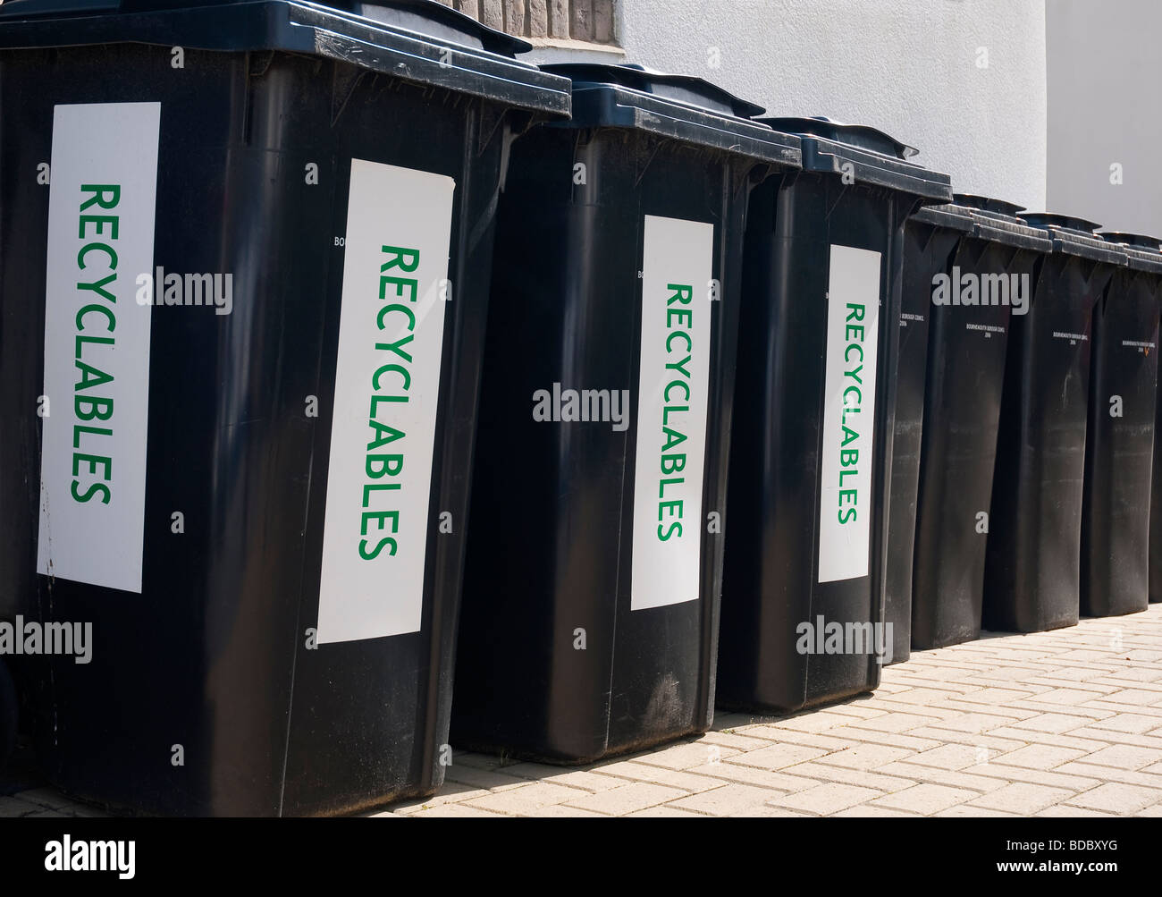 Row of black recycle wheelie bins Stock Photo Alamy