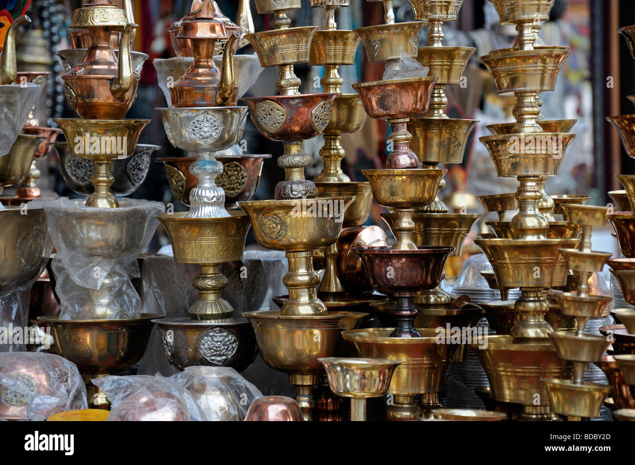 brass oil burners chalices for sale in the market bazaar near Boudhanath temple shrine buddhist temple Stock Photo