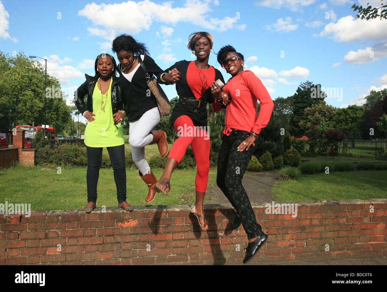 4 stylish black friends jumping together, London, South, Camberwell UK 2009 Stock Photo