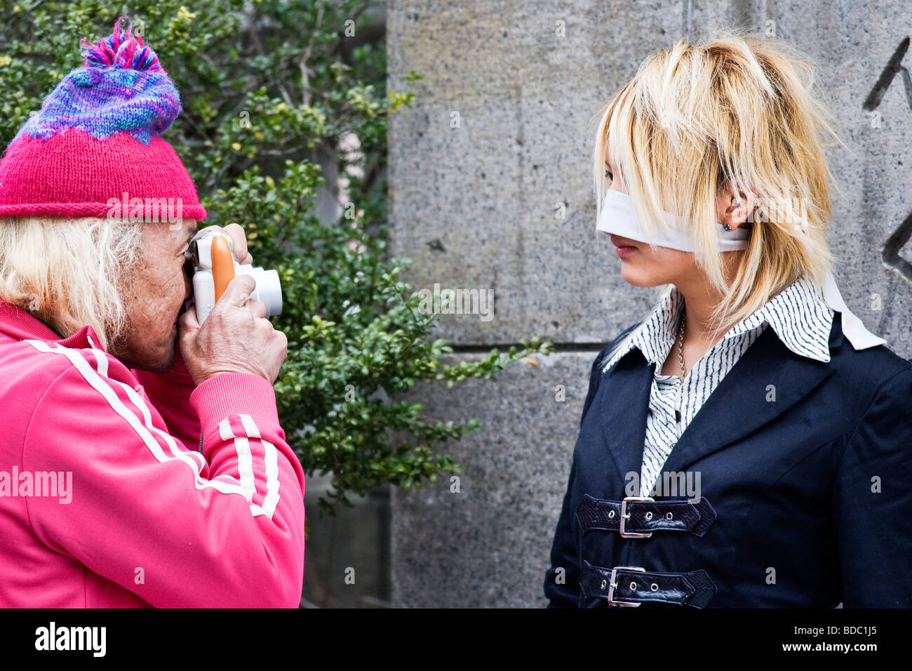 A man taking a photograph of a young person in fancy dress Harajuku, Tokyo, Japan Stock Photo