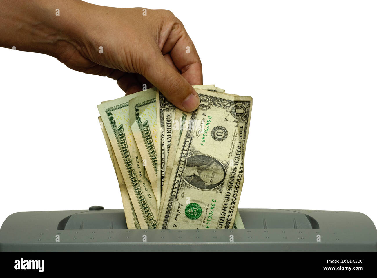 Male hand feeding several dollar bills into a shredder Saved including
