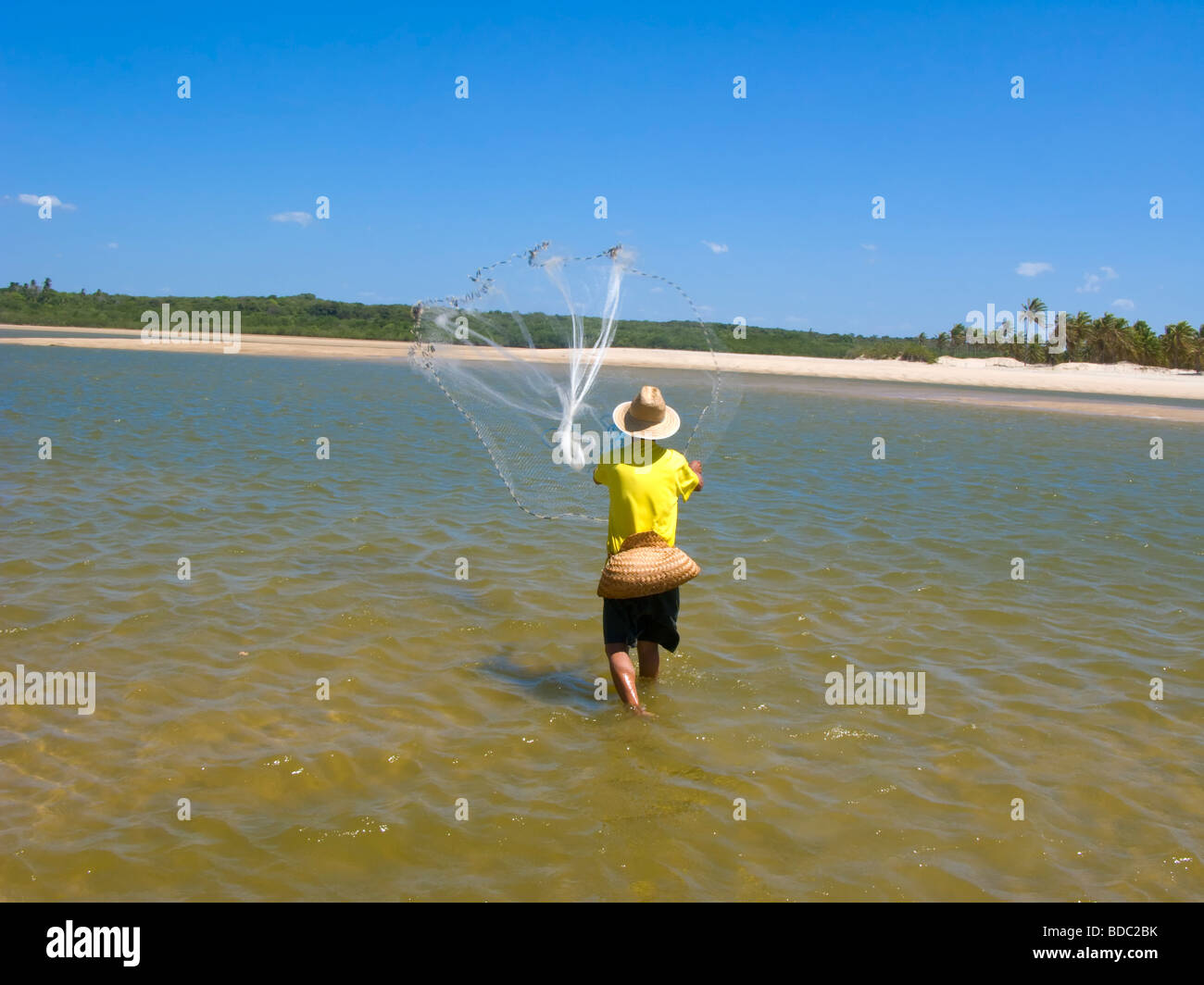 Local fisherman throwing fishing net hi-res stock photography and