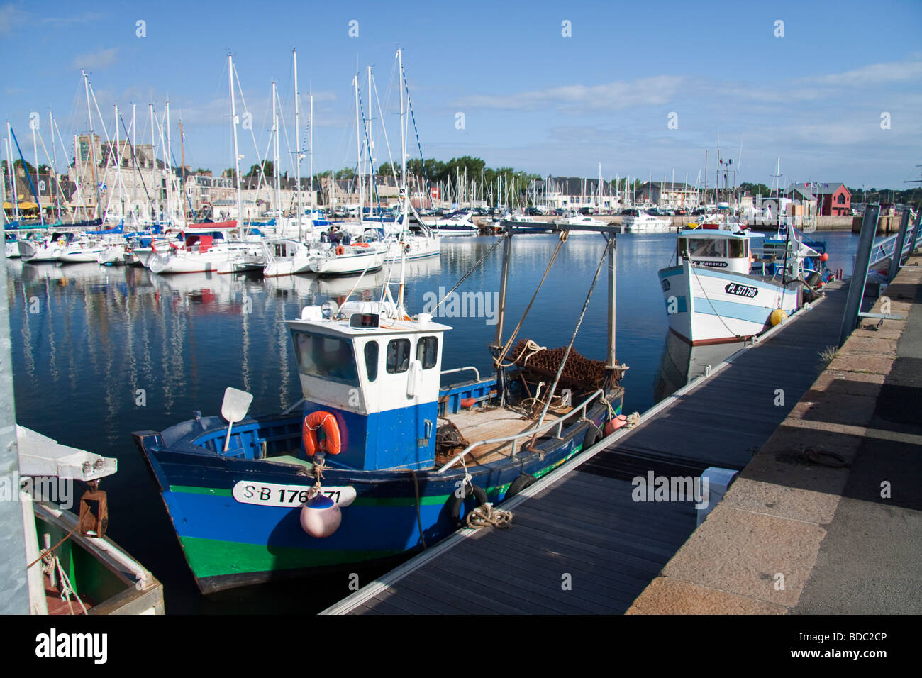 Fishing boats alongside their moorings in Paimpol Harbour. Stock Photo