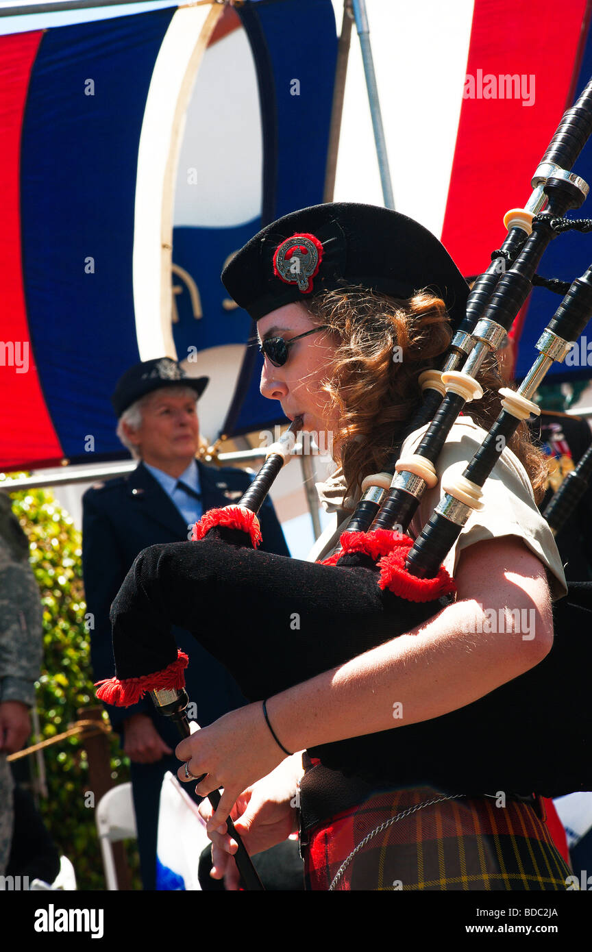 A member of the the Gold Coast Pipe Band is playing her bagpipe during the 4th of July parade in Santa Barbara. Stock Photo
