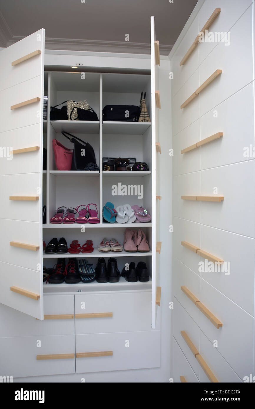 shoe wardrobe with doors on Close Up Of Shoes On Shelves In Fitted Wardrobe With Doors Open Stock Photo Alamy