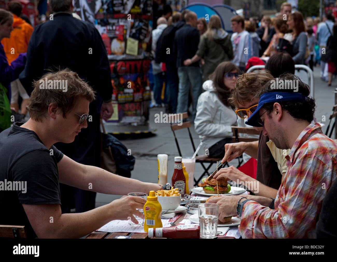 Guys dining out during Edinburgh fringe Festival, Edinburgh High Street Scotland, UK Europe Stock Photo
