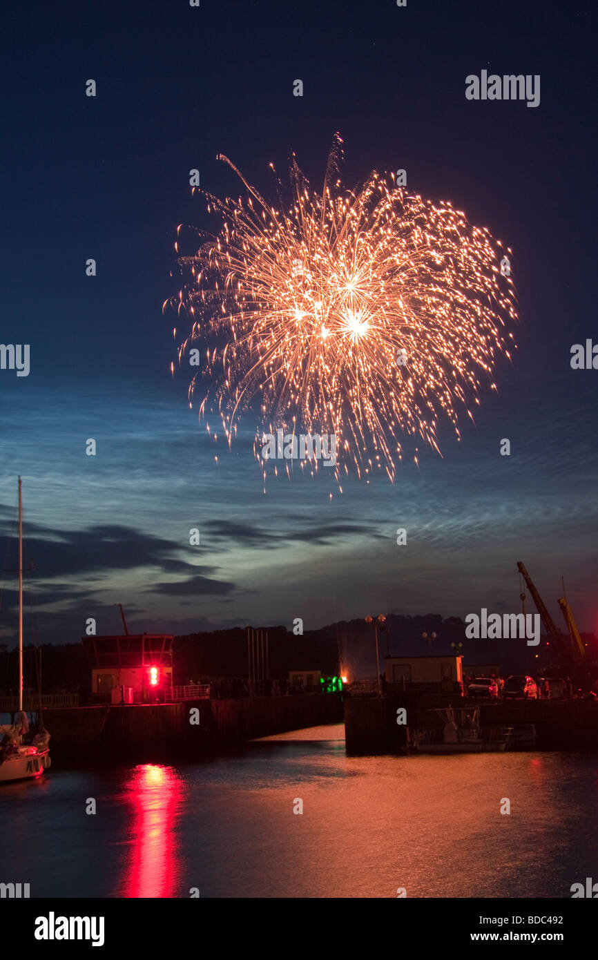 Fireworks on Bastille Day, 14th July, over the harbour and sea lock at Paimpol, Brittany, Northern France. Stock Photo
