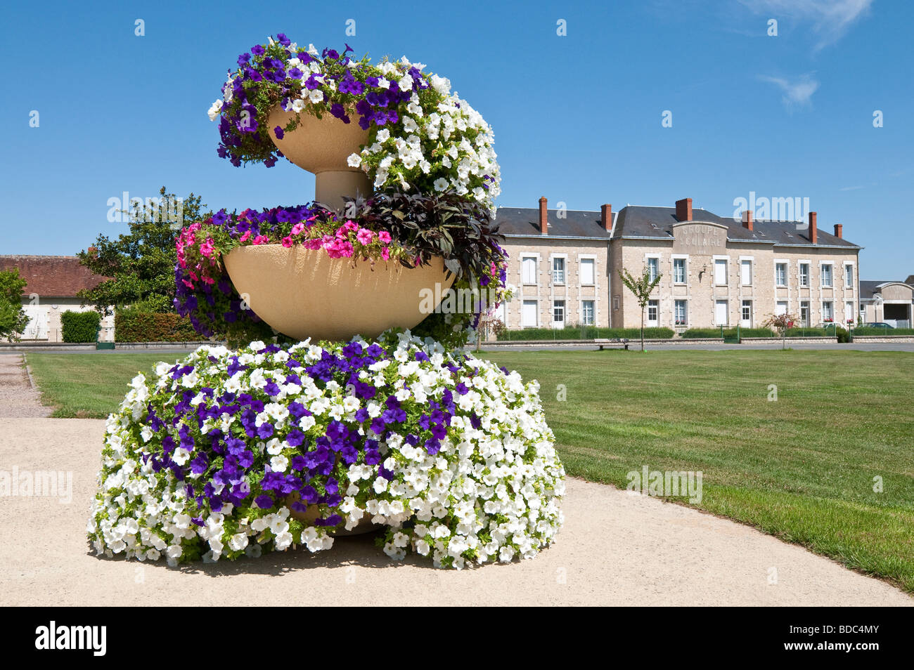 Multicoloured Begonias in round planter - Martizay, Indre, France. Stock Photo