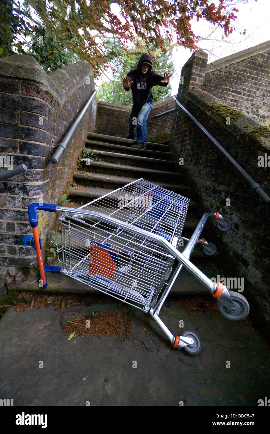 Throwing shopping trolley down railway stairs Stock Photo Alamy