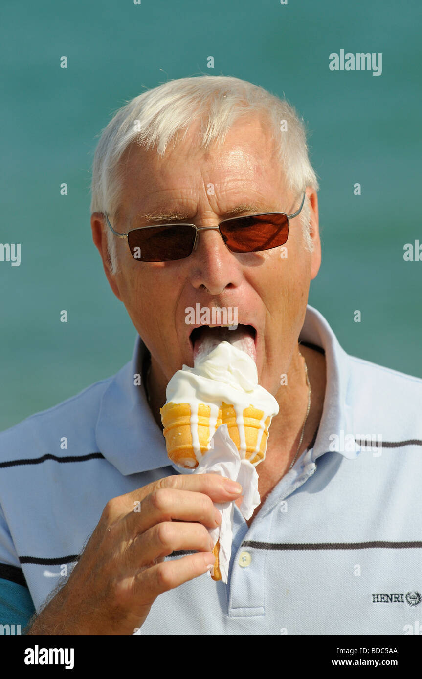Portrait of an elderly man with grey hair eating an ice cream cornet Stock  Photo - Alamy