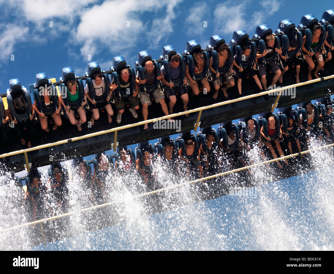 People on Riptide thrill ride descending towards the fountains of water Stock Photo
