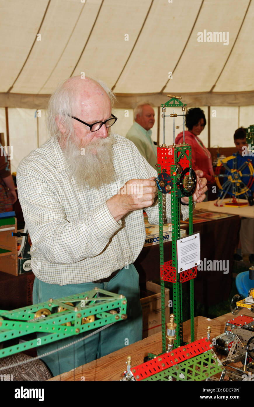 a maccano enthusiast demonstrates a model at an exhibition in cornwall, uk Stock Photo