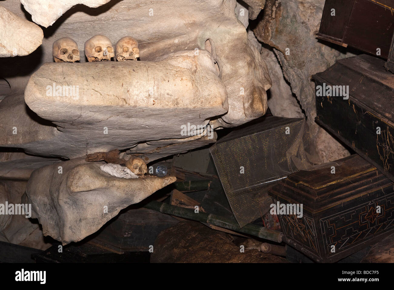 Indonesia Sulawesi Tana Toraja Londa village burial cave skulls on rock ledge above pile of coffins Stock Photo