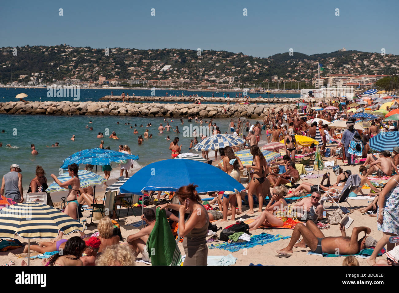 On the public beach at Juan les Pins in July Stock Photo