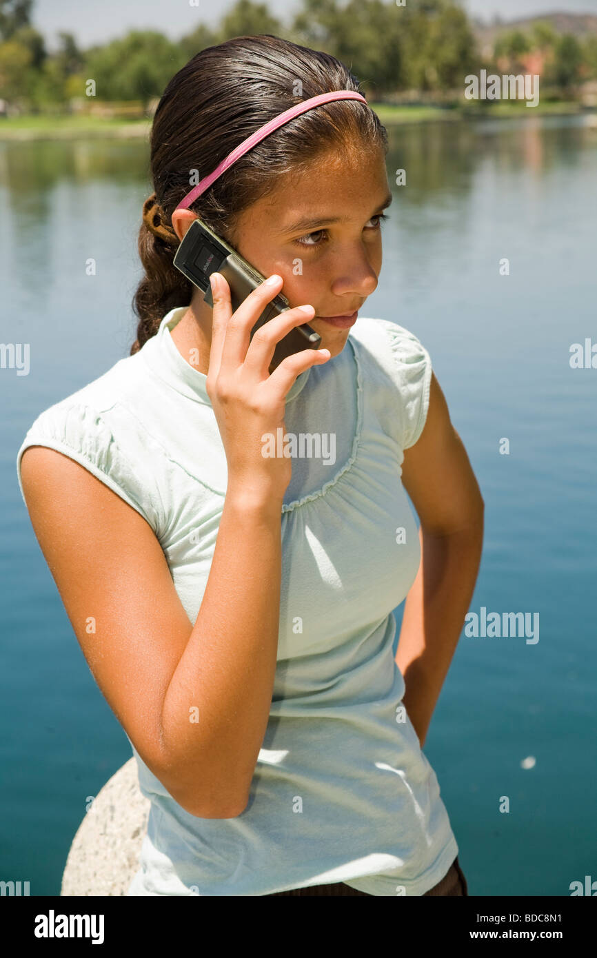 11-13 year old years young person people  Hispanic girl talking on mobile phone. Tween tweens young person people nature, natural surrounding MR © Myrleen Pearson Stock Photo