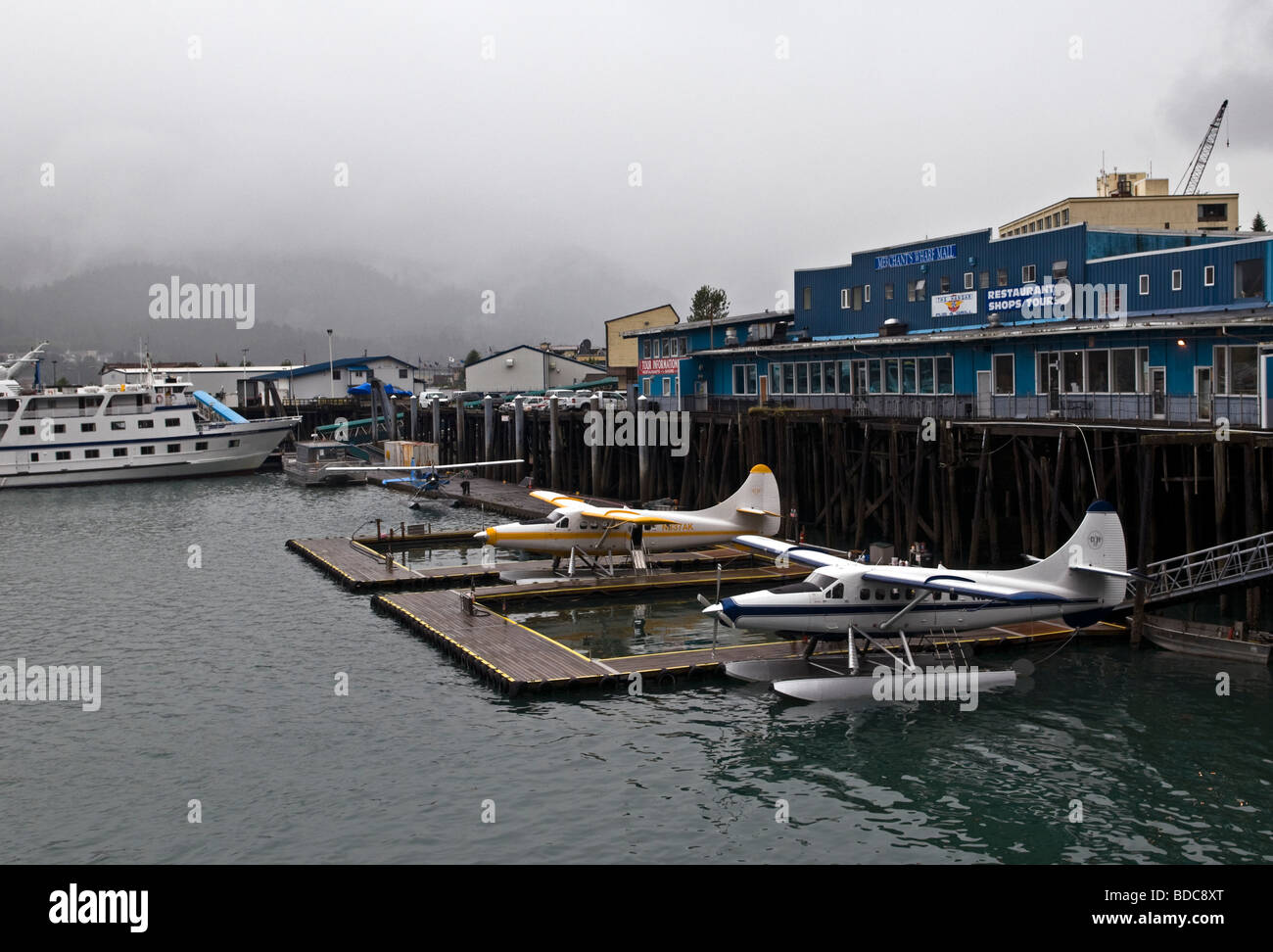 Sightseeing seaplanes parked at the water front on a foggy morning in Juneau Alaska Stock Photo