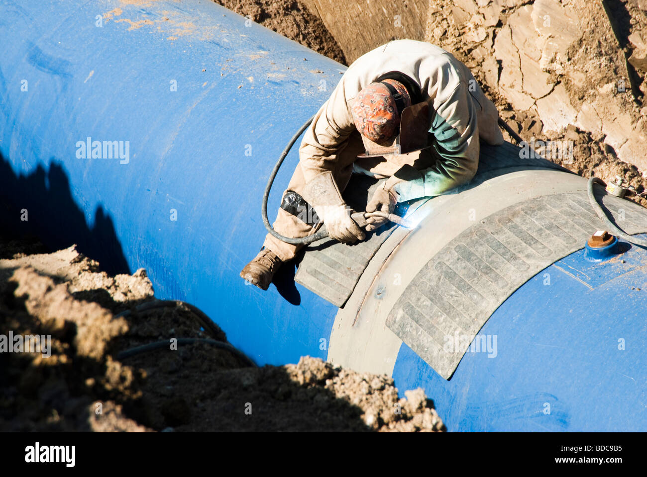 a welder working at the Louis & Clark Regional Water System pipeline construction site in South
