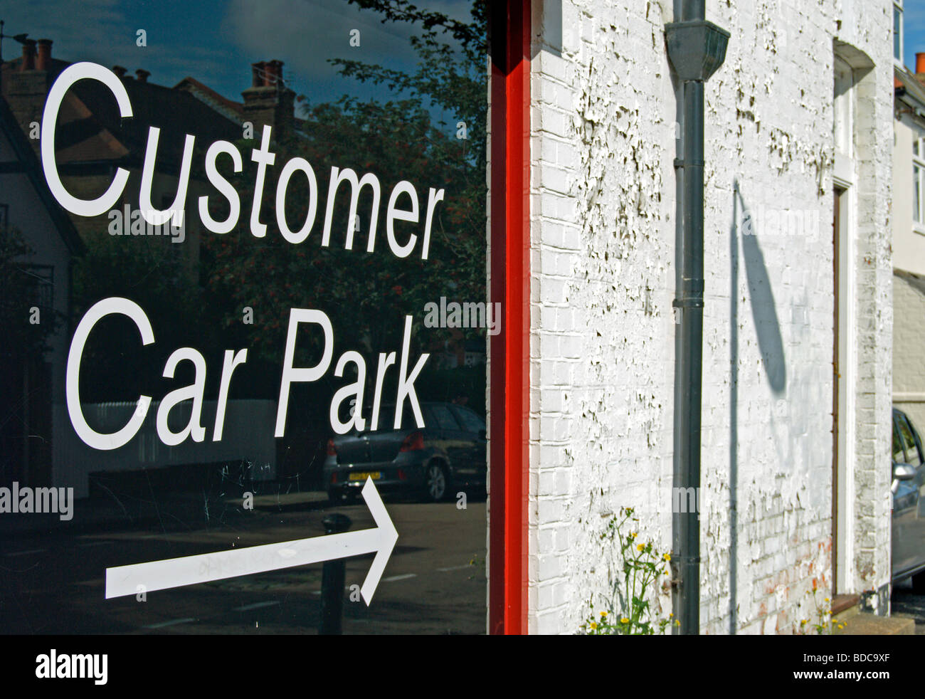 sign with arrow giving directions to customer car park, in east sheen