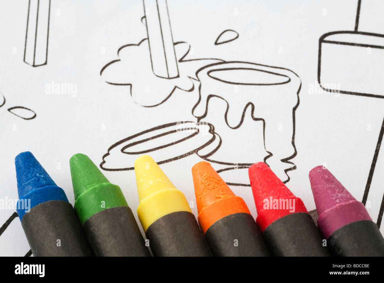 Wax coloured crayons on children's line drawing for colouring in a sketch pad Stock Photo