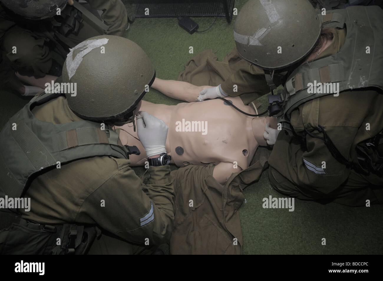 Israeli paramedic soldiers practicing CPR in a plastic resus dummy in the IDF military paramedic training school in Israel Stock Photo