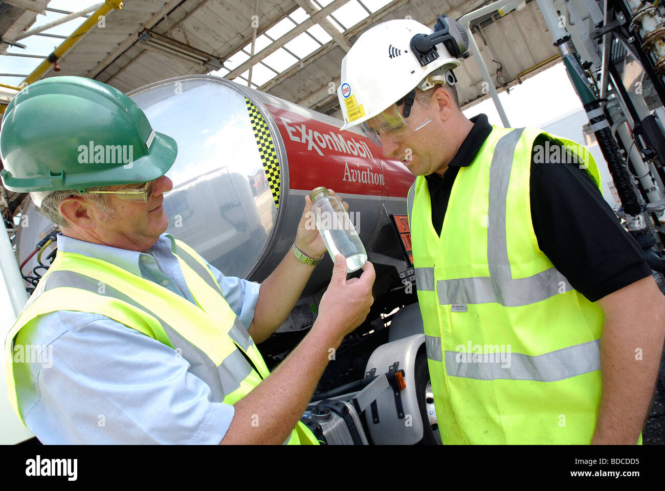 Technicians checking a sample of aviation fuel Stock Photo