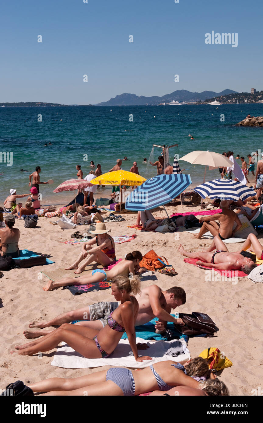 On the public beach at Juan les Pins in July Stock Photo