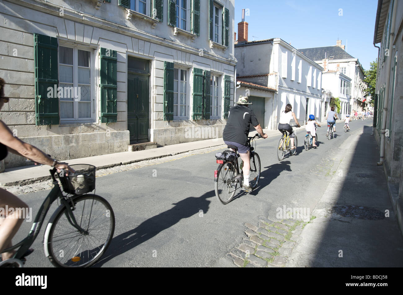 Cyclists on the backstreets of St Martin de Re Stock Photo