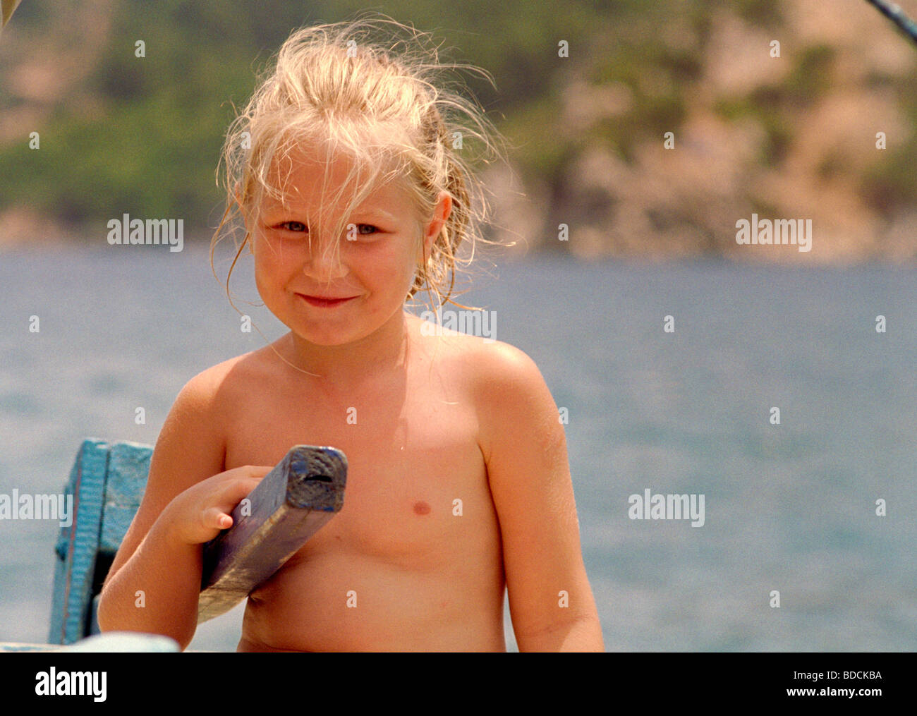 Young Girl Smiling Steering A Boat Stock Photo Alamy