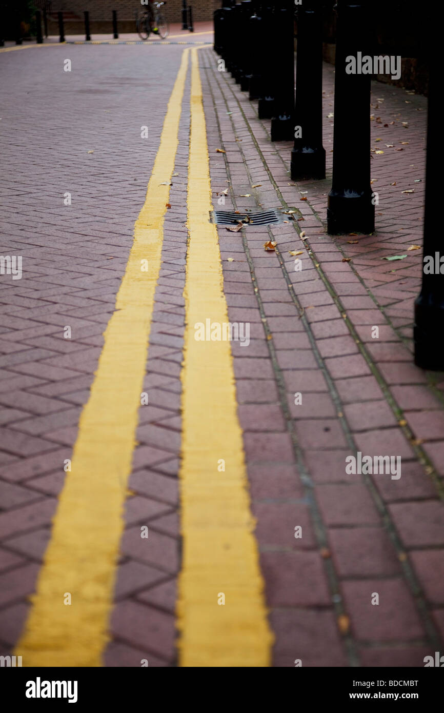 Double yellow lines. These stripes mean there is no parking allowed. Stock Photo