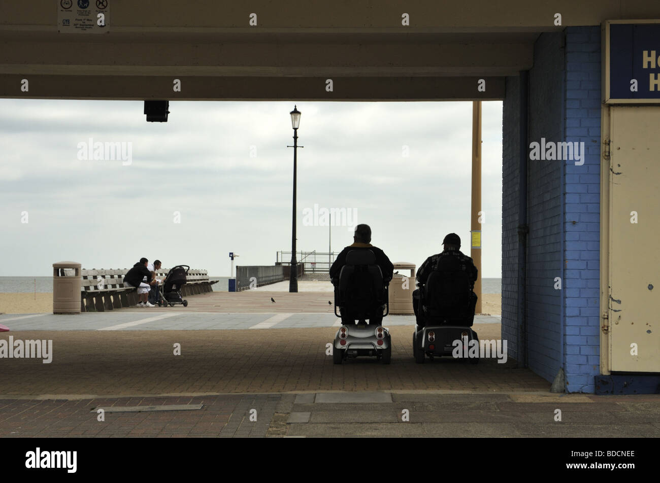 A couple on mobility scooters, Great Yarmouth, Norfolk, UK Stock Photo