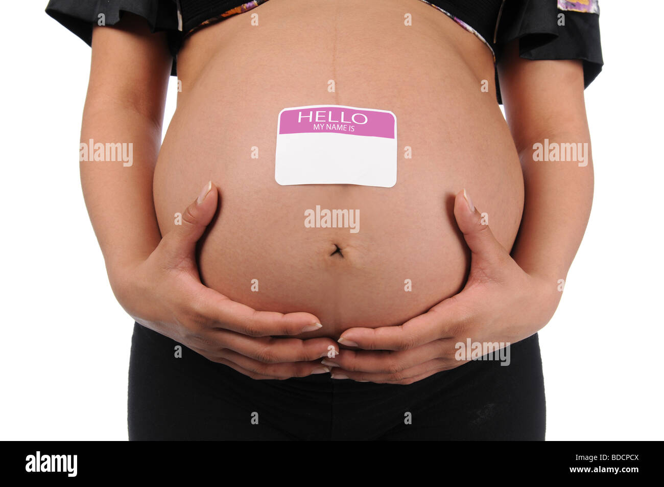 Pregnant woman holding stomach with name tag Stock Photo