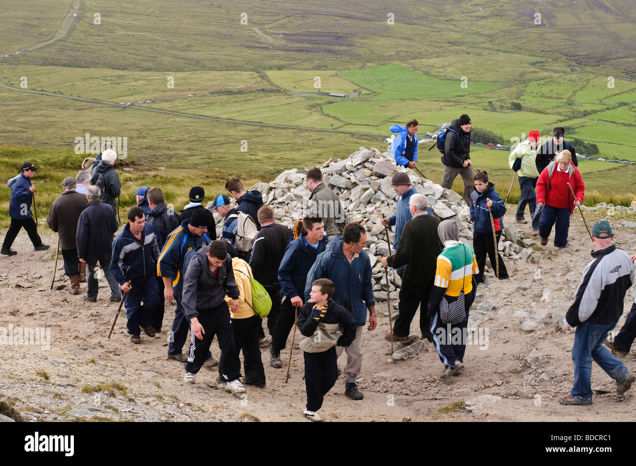 Pilgrims with walking stick circling the first station at Croagh Patrick on Reek Sunday, 25th July 2009 Stock Photo