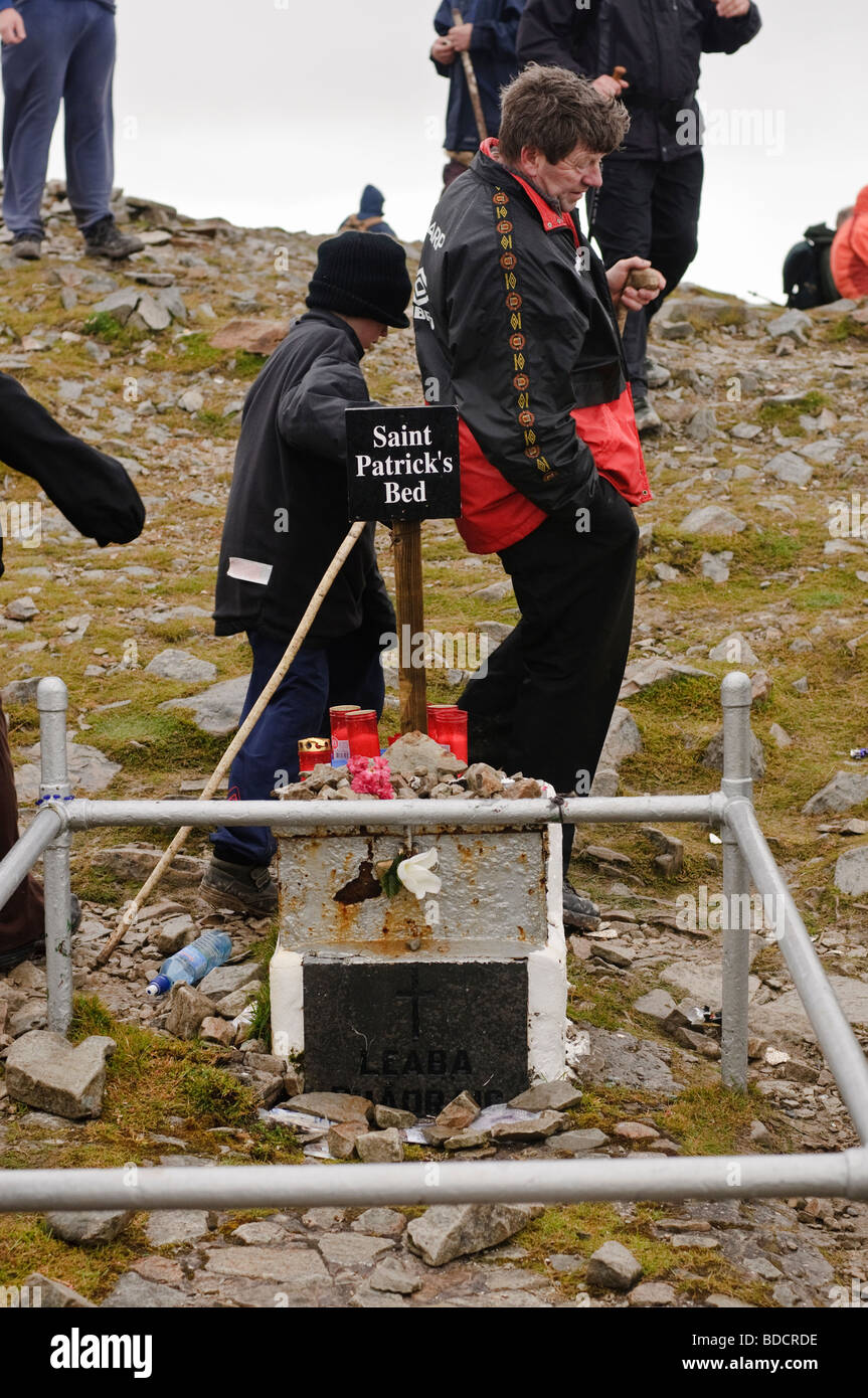 Pilgrims with walking sticks circling St Patrick's bed on the summit of Croagh Patrick on Reek Sunday, 25th July 2009 Stock Photo