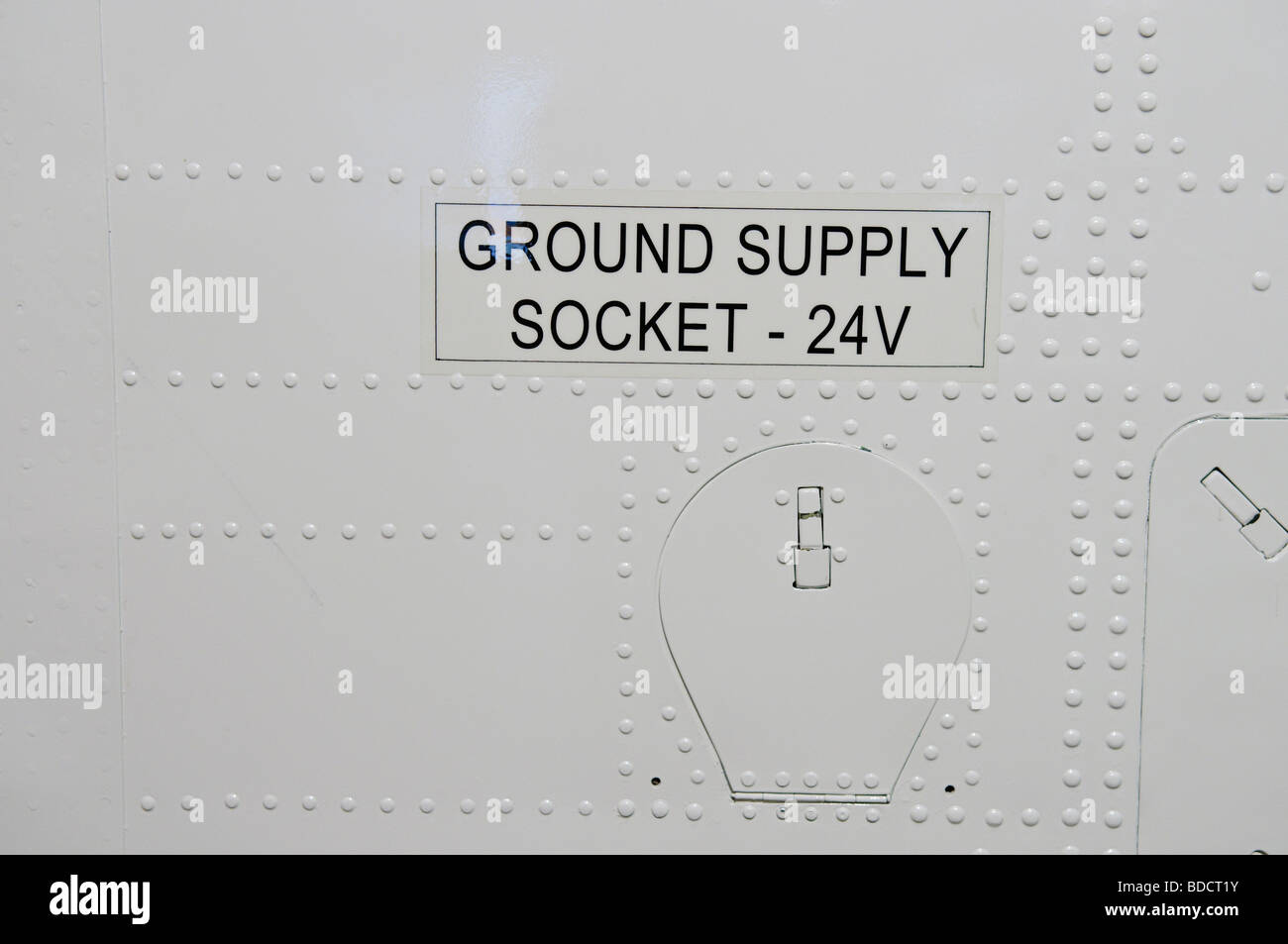 24v Ground Supply Socket on the side of an airplane Stock Photo