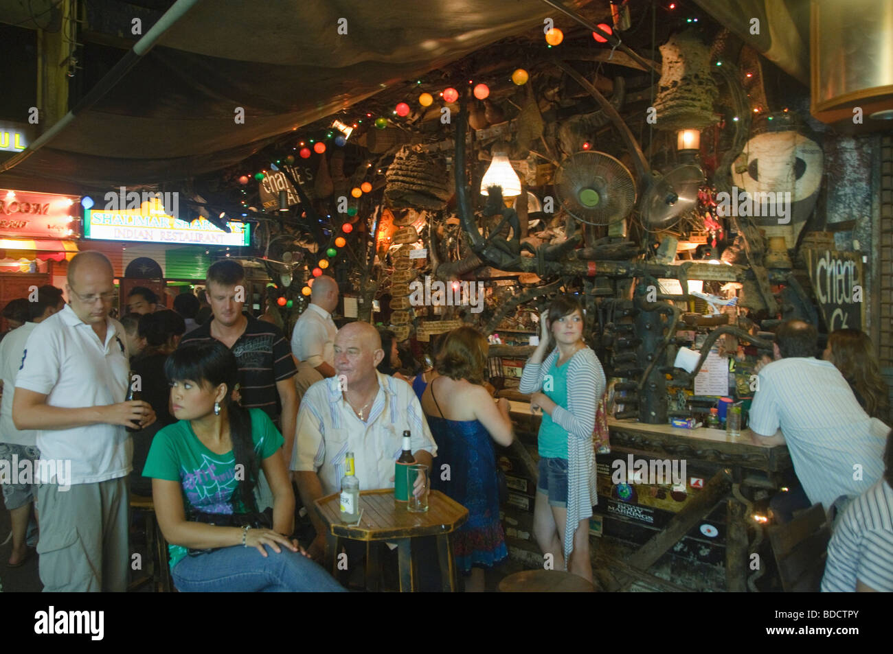 party goers drinking at Cheap Charlies Bar in Bangkok Thailand Stock