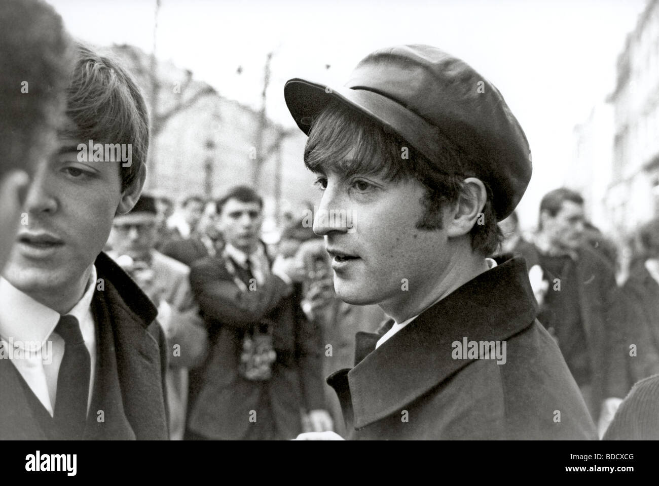 BEATLES - Paul McCartney at left with John Lennon on the Champs Elysee in Paris in January 1964 Stock Photo