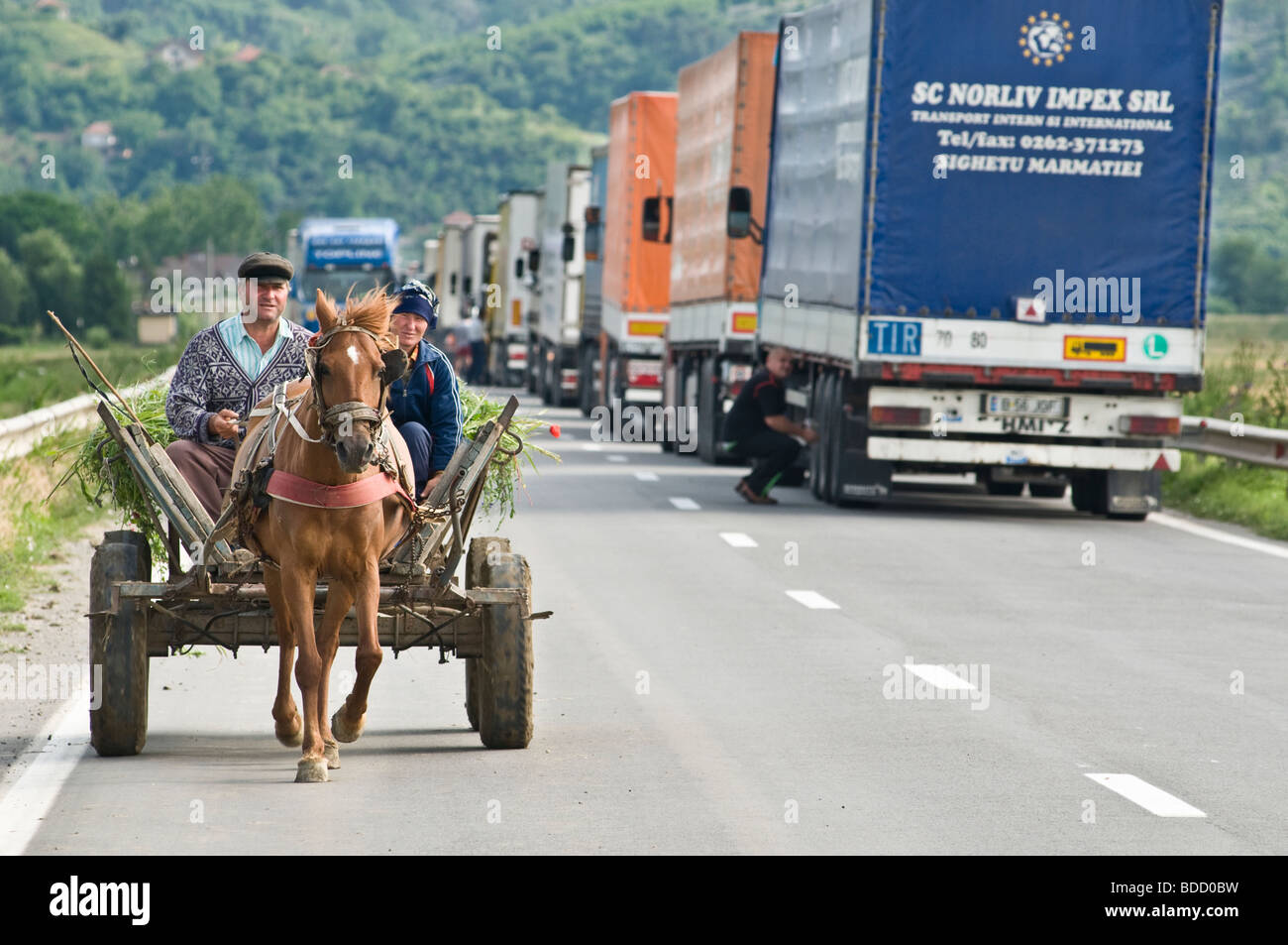 horse and wagon at Bulgarian-Romanian border, trucks waiting at border to cross river Stock Photo