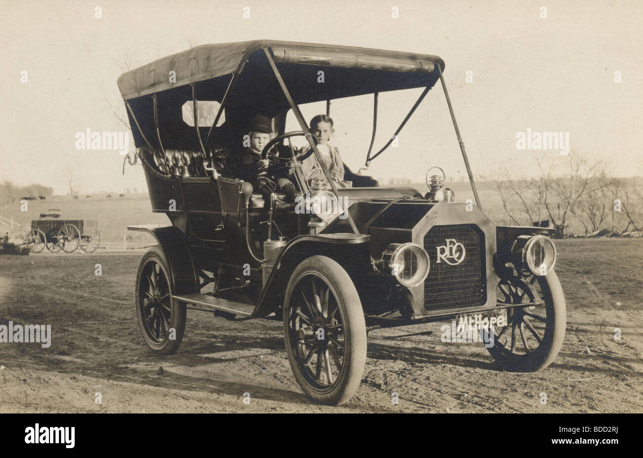 Two Little Children Driving Reo Touring Car Stock Photo