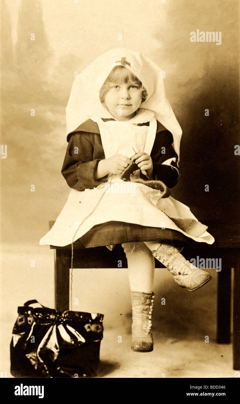 Little Girl Red Cross Nurse Knitting Stock Photo