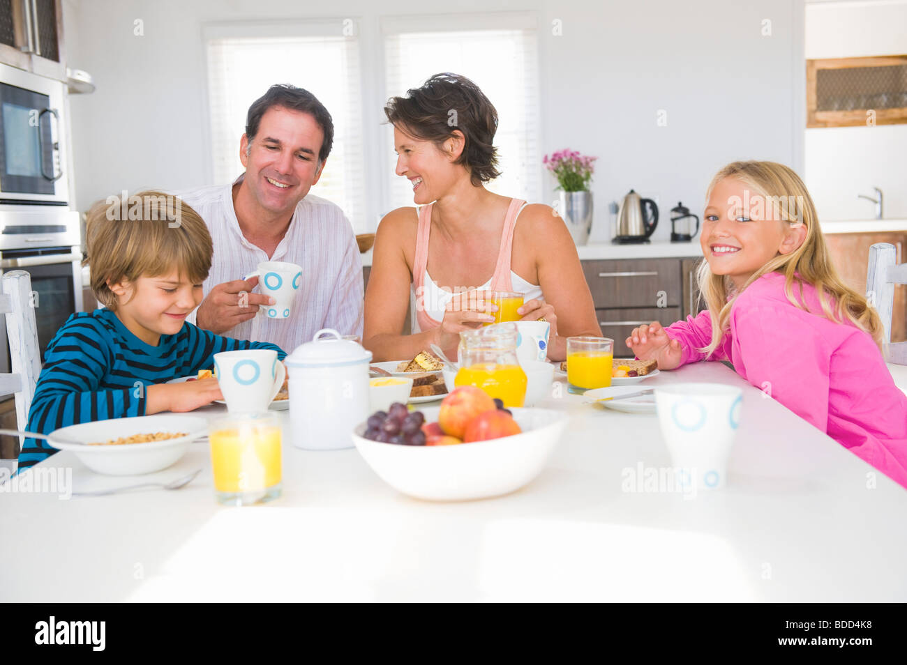 Family having breakfast at the dining table Stock Photo - Alamy