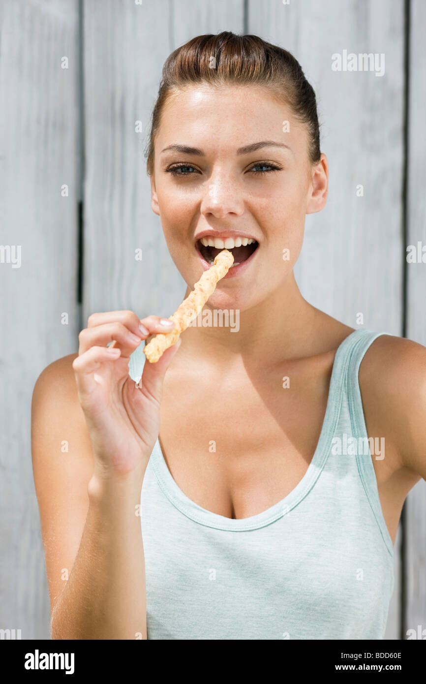 Portrait of a woman eating a breadstick Stock Photo Alamy