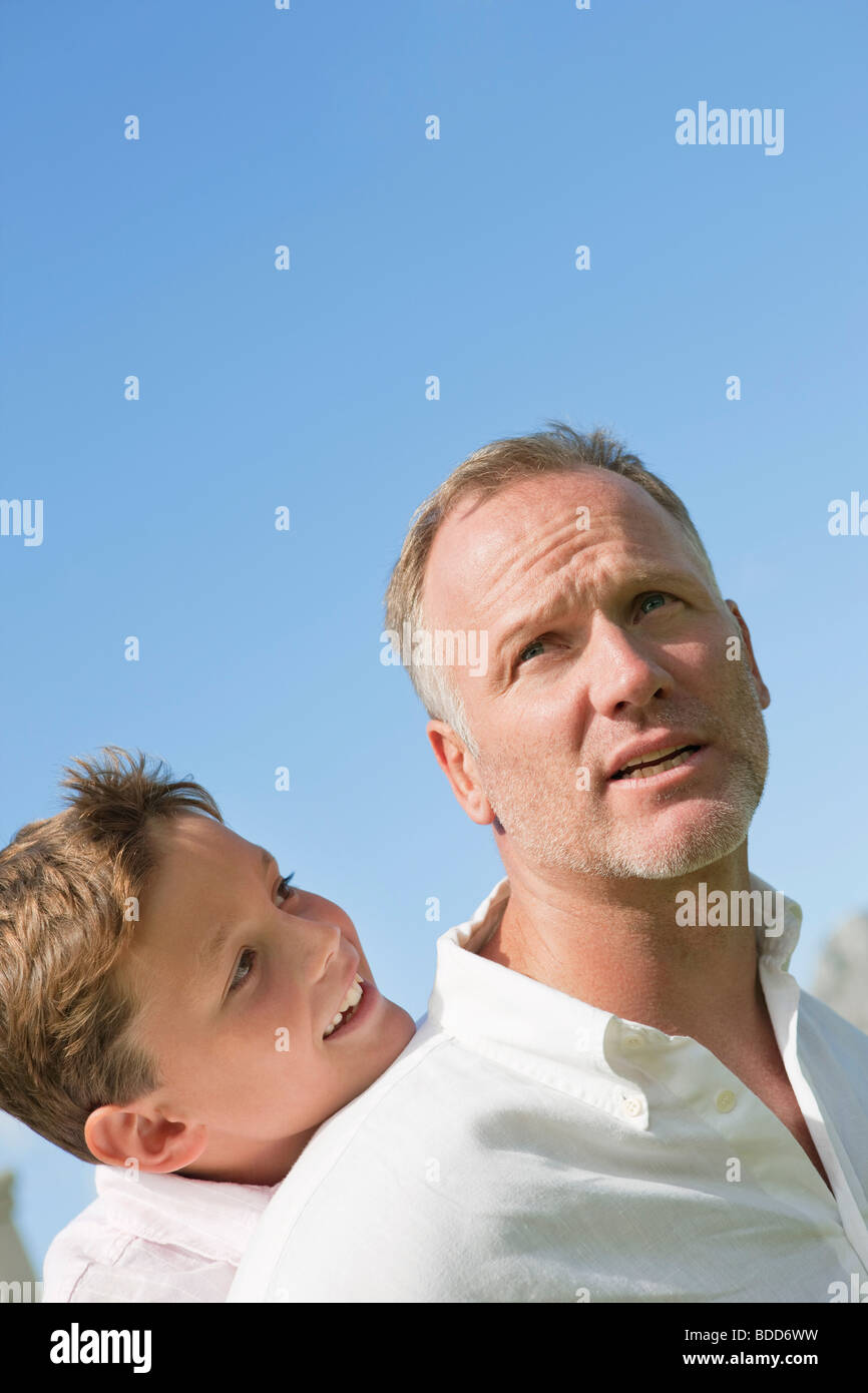 Boy riding piggyback on his father Stock Photo - Alamy