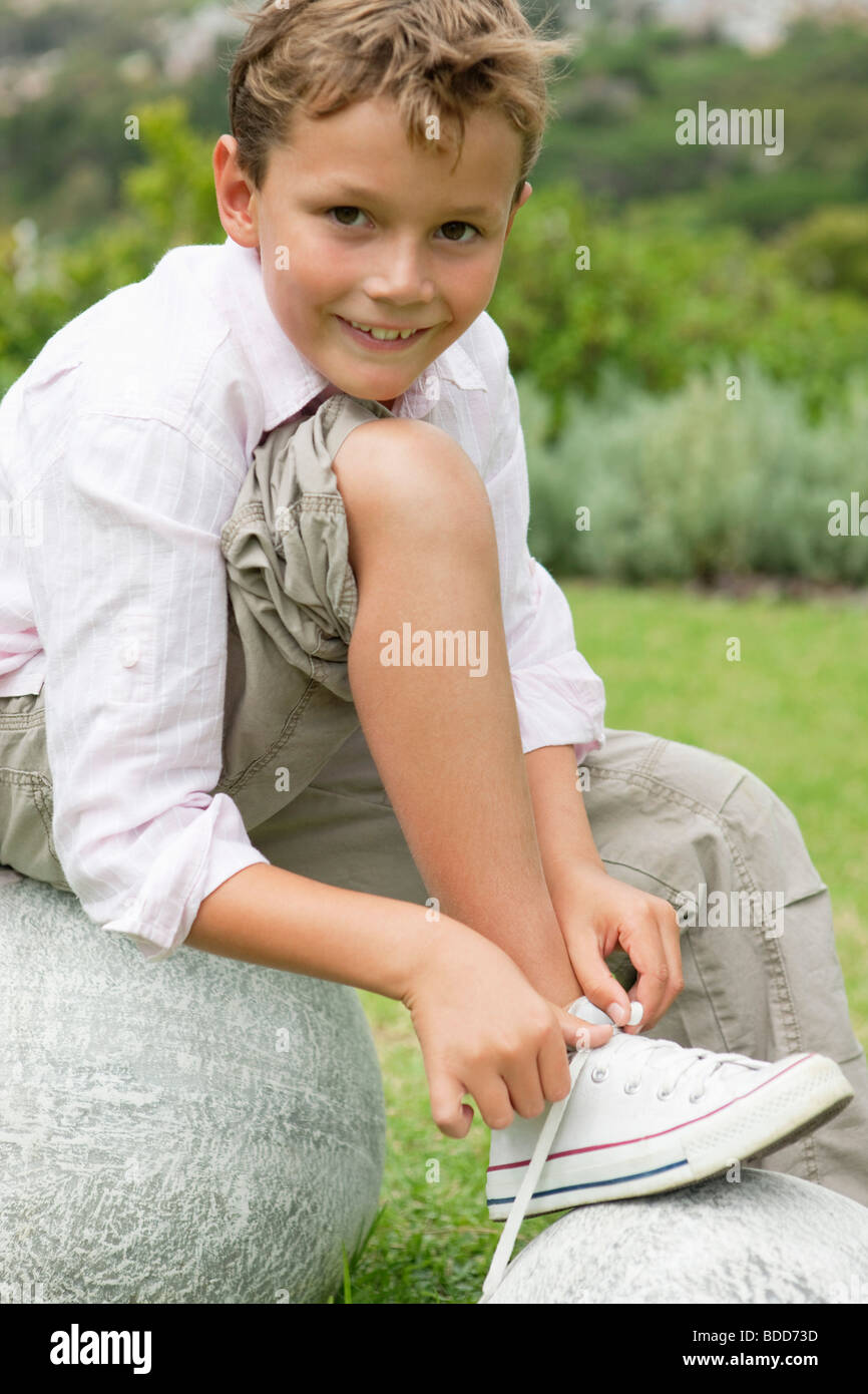 Boy tying his shoelaces Stock Photo Alamy