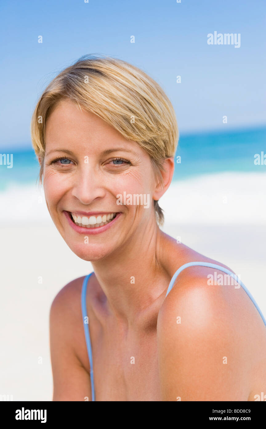 Portrait of a woman smiling on the beach Stock Photo - Alamy