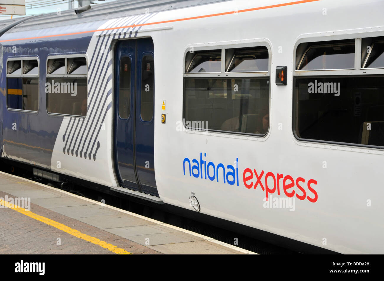National Express franchise brand logo on side of passenger train railway carriage waiting at station platform London England UK Stock Photo