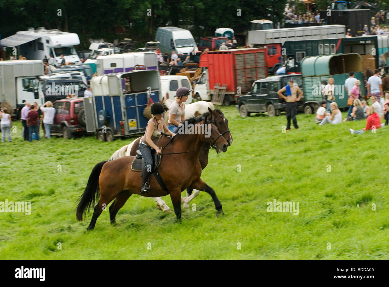 Young girls horseback riding. Priddy Horse Fair Mendip Hills, Somerset Uk 20009 2000s HOMER SYKES Stock Photo