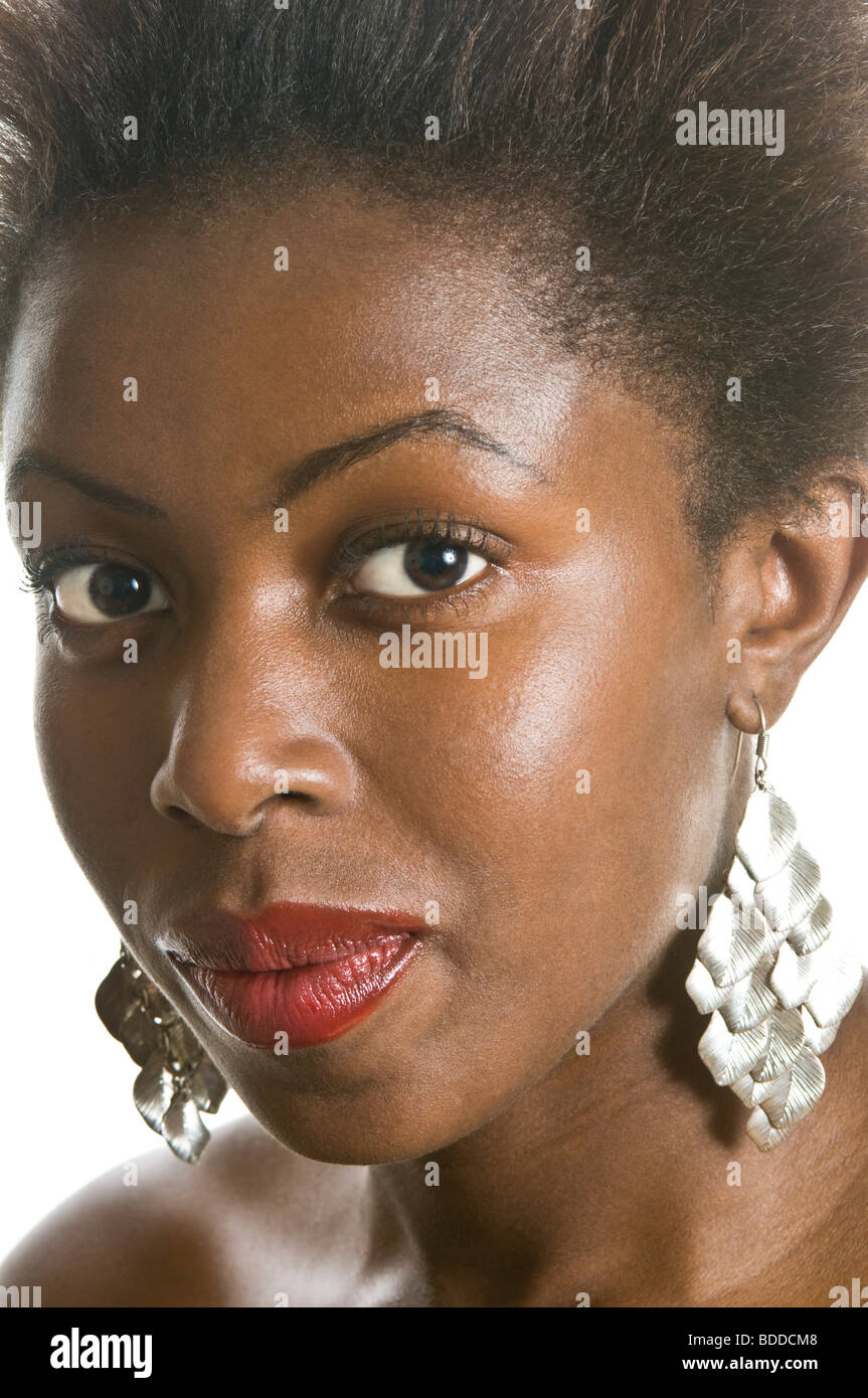 Portrait of a young attractive African woman with long dangly silver earrings on against a pure white (255) background. Stock Photo