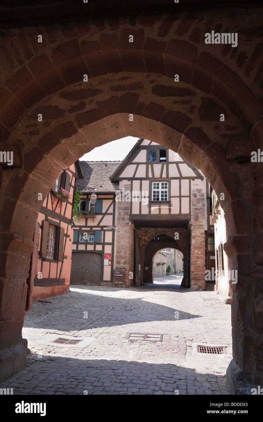 Riquewihr, Alsace, Haut-Rhin, France, Europe. View through Dolder tower arch to town walls gateway in medieval commune Stock Photo