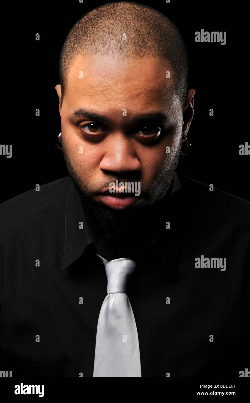 Portrait of African American man with white tie over a black background Stock Photo